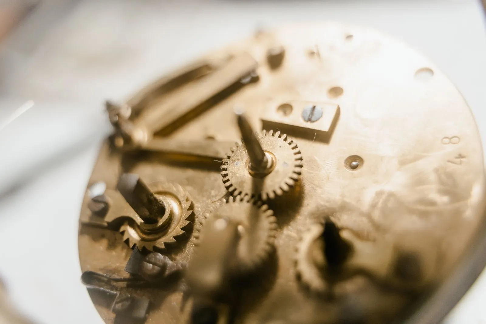Detailed view of a vintage clockwork mechanism showcasing intricate gears and metallic components.